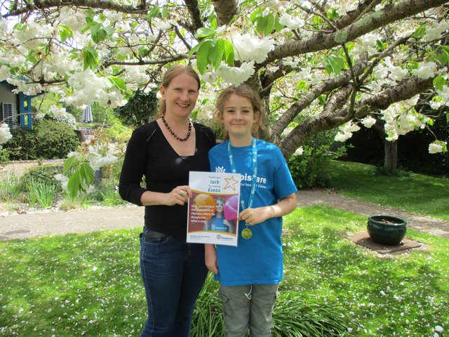 Jack with his mum Jo after receiving his medal and certificate from Hospiscare