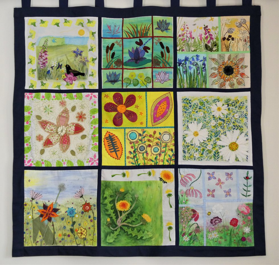 The hanging, consisting of nine panels of textile flowers, is on display in Okehampton Medical Centre.